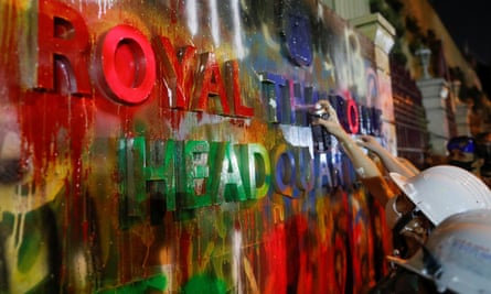 Pro-democracy protesters spray paint signage on Thailand’s police headquarters