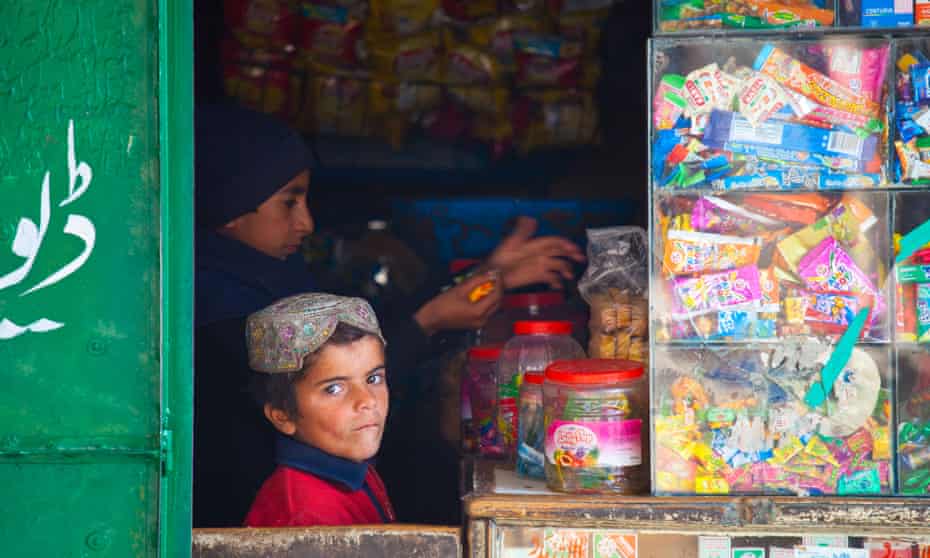 Boys are seen in a sweet shop in Punjab province, Pakistan