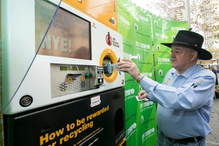 Ian Kiernan of Clean Up Australia deposits a plastic bottle into the Envirobank, a reverse vending recycling machine, in Sydney.