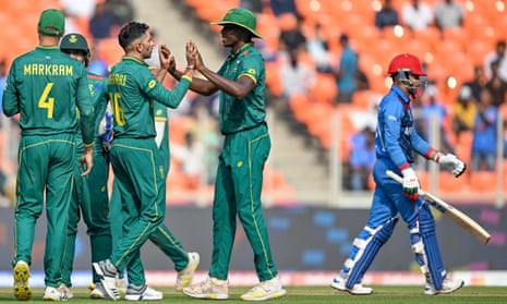 South Africa's Keshav Maharaj (second left) celebrates with teammates after taking the wicket of Afghanistan's Rahmanullah Gurbaz (right).