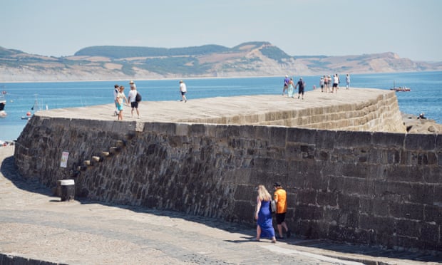The Cobb in Lyme Regis with Golden Cap and Seatown in the distance