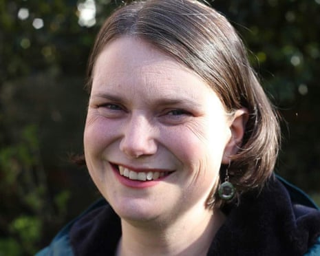 Sarah Wakefield smiling against a blurred green background