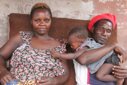 Future Mwembe and her husband Clement Dube sit outside their home.