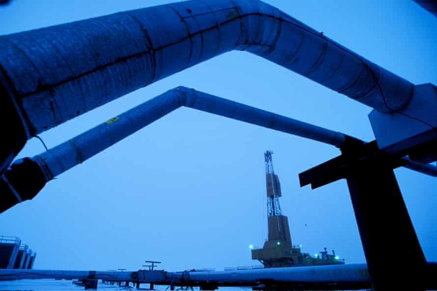 An oil well drilling rig and pipelines in a BP oilfield near Prudhoe Bay.