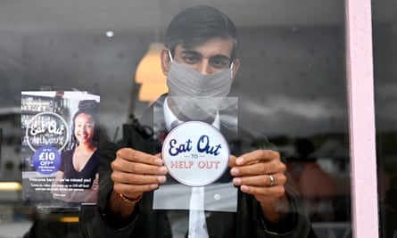 The chancellor Rishi Sunak, placing an ‘Eat Out to Help Out’ sticker in the window of a business during a visit to Rothesay on the Isle of Bute, Scotland in August 2020.