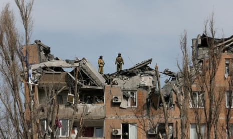 Firefighters work at a residential building damaged by shelling in the separatist-controlled city of Donetsk, Ukraine March 30, 2022.