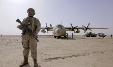 A Saudi soldier stands near an air force cargo plane at an airfield in Yemen’s central province of Marib.