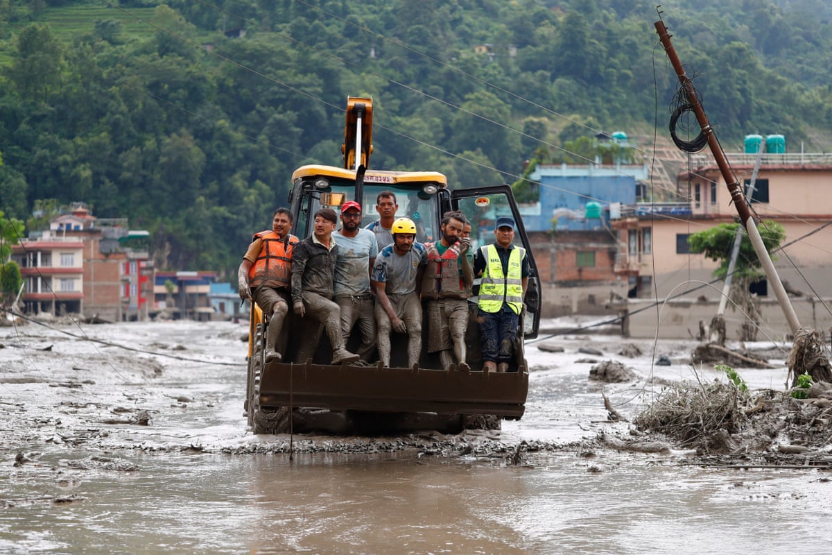 Rescue crews use a bulldozer to help people in buildings