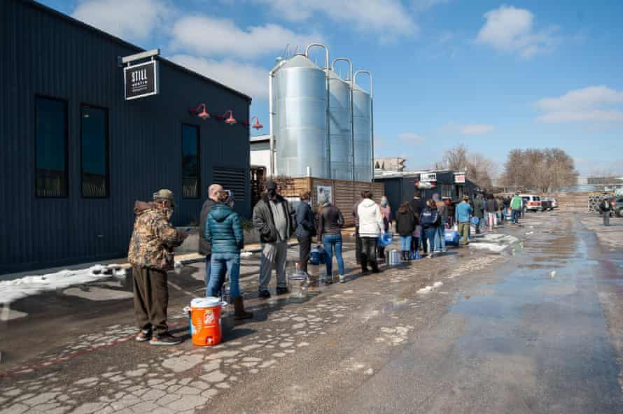 People wait in line at St Elmo Brewery for free potable water in Austin.
