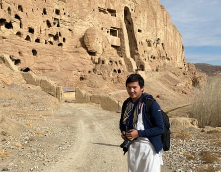 Mortaza Behboudi, stands in front of the empty seat of the Buddha destroyed by the Taliban in Bamiyan, central Afghanistan.