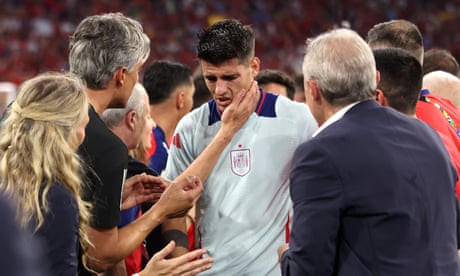 Alvaro Morata is consoled as he leaves the field after being knocked over.