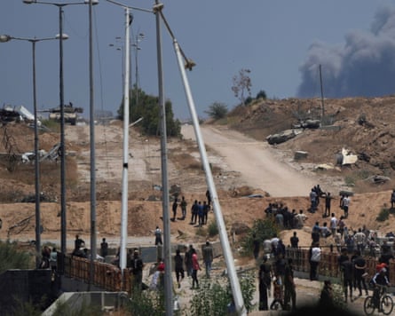 Israeli tanks overlook a humanitarian aid distribution centre in Khan Younis.
