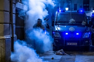 Firecracker smoke on Vía Laietana in Barcelona. Police officers and vans cleared the streets