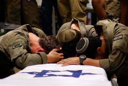 Israeli soldiers mourn over the coffin of Reei Biran, an army captain