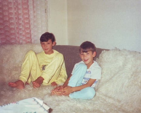 Džemil Hodžić, as a boy, sits with his brother Amel on a sofa, smiling