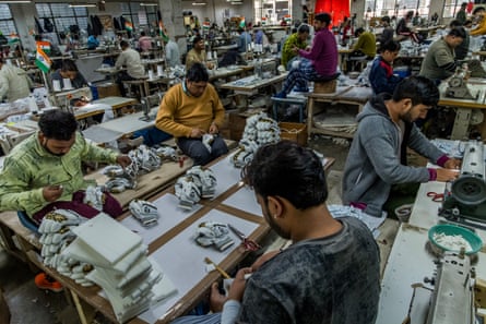 Workers sew gloves in the factory of Sanspareils Greenlands, India’s largest manufacturer and exporter of cricket equipment.