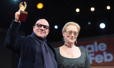 Director Gianfranco Rosi  holds his Golden Bear for best film next to US actor and jury president Meryl Streep