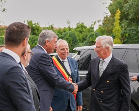 Belgium's King Philippe shakes hands with Belgium's Deputy prime minister Jan Jambon as he visits with emergency teams and volunteers involved in fighting a wildfire in Vottem, Belgium.