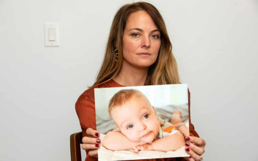 Elle Cavatore poses with a photo of her deceased baby, James, at her home in Houston, Texas.