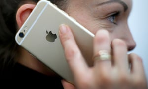 A woman holds an iPhone