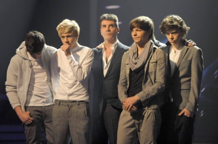 Judge Simon Cowell (centre) with members of boyband One Direction on The X Factor TV show, London, Britain - 11 Dec 2010