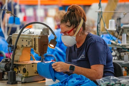 A worker makes scrubs for frontline NHS staff in O’Neills sportswear factory in Strabane in Northern Ireland