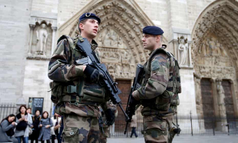 Soldiers stand guard in front of the Notre Dame cathedral in Paris. 