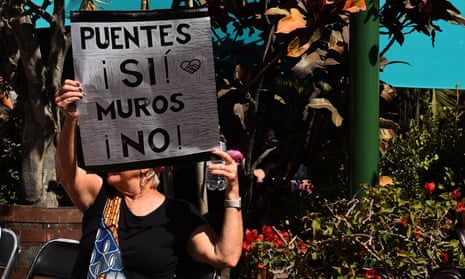 A woman holds a sign that reads: ‘Bridges yes, walls no’ during the Women’s March in Ajijic, a town in Jalisco state, Mexico.