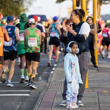 Spectators cheer on the runners
