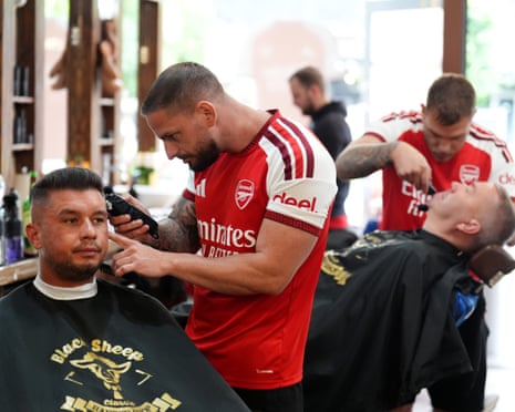 Barbers wearing Arsenal shirts in Budapest.