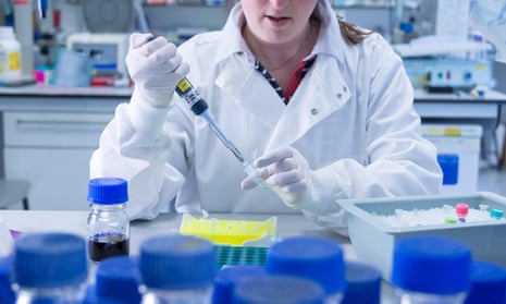 Woman in lab using pipette.