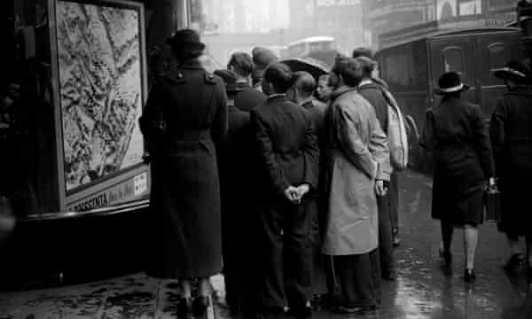 A small crowd in Fleet Street, London, looking at a map of Abyssinia in October 1935.