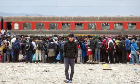TOPSHOTS Migrants and refugees board a train after crossing the Macedonian-Greek border near Gevgelija.