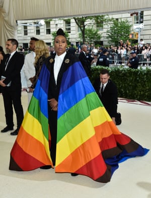 She declared she didn't want to blend in and there was no doubt writer and actor Lena Waithe stood out on the Met Gala red carpet by wearing a suit and LGBTQ pride-flag cape designed by Carolina Herrera.