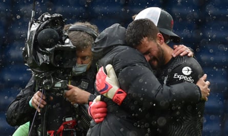Alisson hugs Liverpool’s manager Jürgen Klopp after the final whistle.