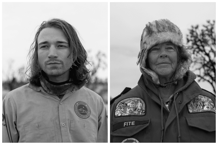 A young man with long hair stands for a portrait, an older woman in a fur hat and large jacket stands for a portrait