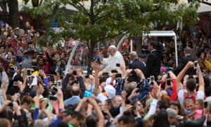 Pilgrims wave at Pope Francis as he arrives to close the World Meeting of Families with a mass on the Benjamin Franklin Parkway in Philadelphia.