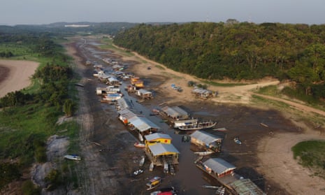 Floating homes and boats stranded on the dry bed of Puraquequara lake in Brazil amid severe drought in October 2023