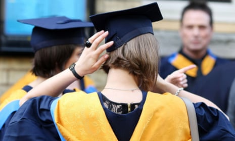 A girl adjusts her graduation hat.