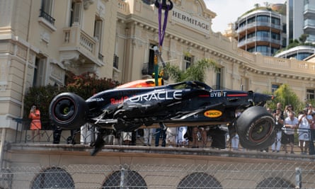 Sergio Pérez’s Red Bull is lifted from the circuit after a first-lap crash