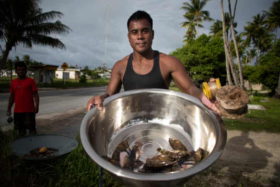 Joseph Iteba shows the fish that he caught to feed his family at Betio.