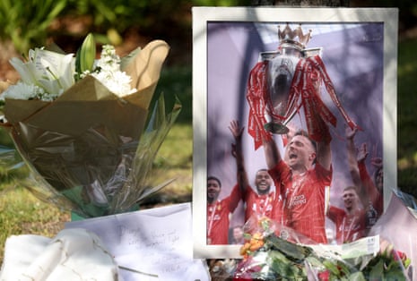 A picture of Diogo Jota stands next to flower tributes