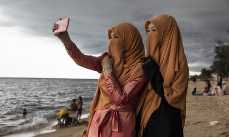Thai women take a selfie on the beach