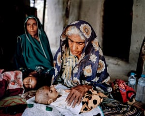 A family cares for four-month-old Shahbaz, who is suffering from diarrhoea and vomiting