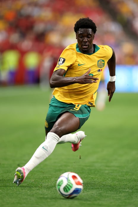 Mohamed Toure #9 of Australia runs with the ball