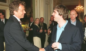 Tony Blair meets Noel Gallagher in 1997, watched by Alan McGee of Creation Records, far right.