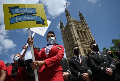 Representatives from the travel industry, including airline cabin crew and pilots, demonstrate during a ‘Travel Day of Action’ outside the Houses of Parliament in central London on June 23, 2021, calling on the UK Government to support a safe return of international travel in time for the peak summer period.