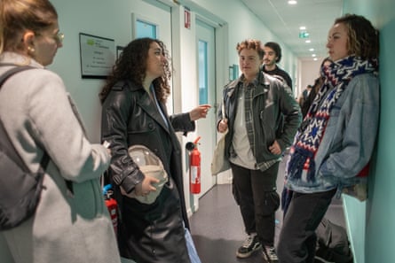 Nihal chats with other people in a hallway