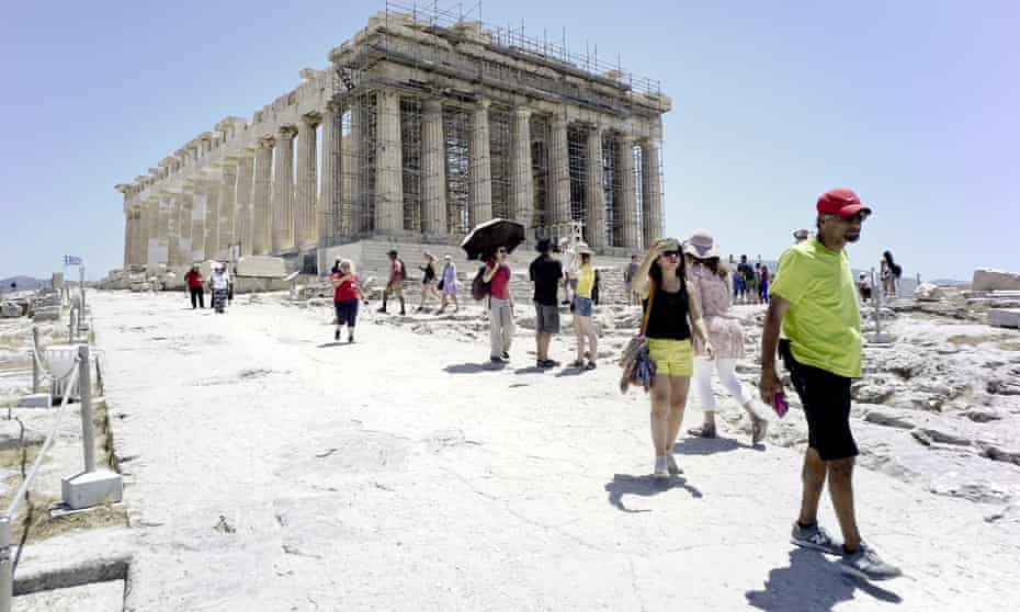 Tourists leave the Acropolis on 4 July in Athens, Greece, after it closed due to high temperatures