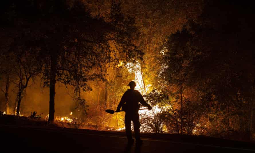 A firefighter watches the river fire near Colfax.